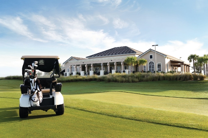 Duran Golf Club Golfcart on Greens with Clubhouse in Background