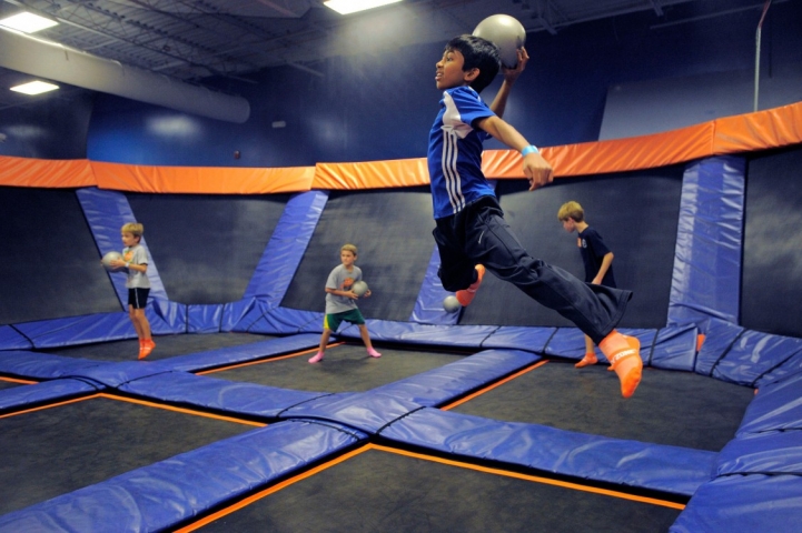 A kid going airborne in a game of dodge ball at Sky Zone Indoor Trampoline Park in Rockledge, FL