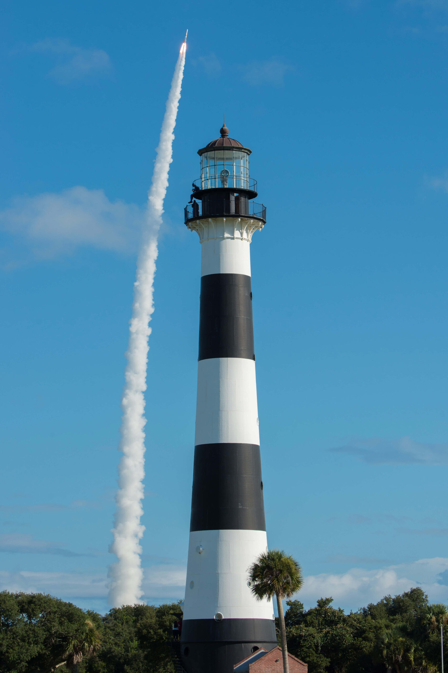 United Launch Alliance's Delta IV launches in the background of the Cape Canaveral Lighthouse (U.S. Air Force photo by James Rainier)