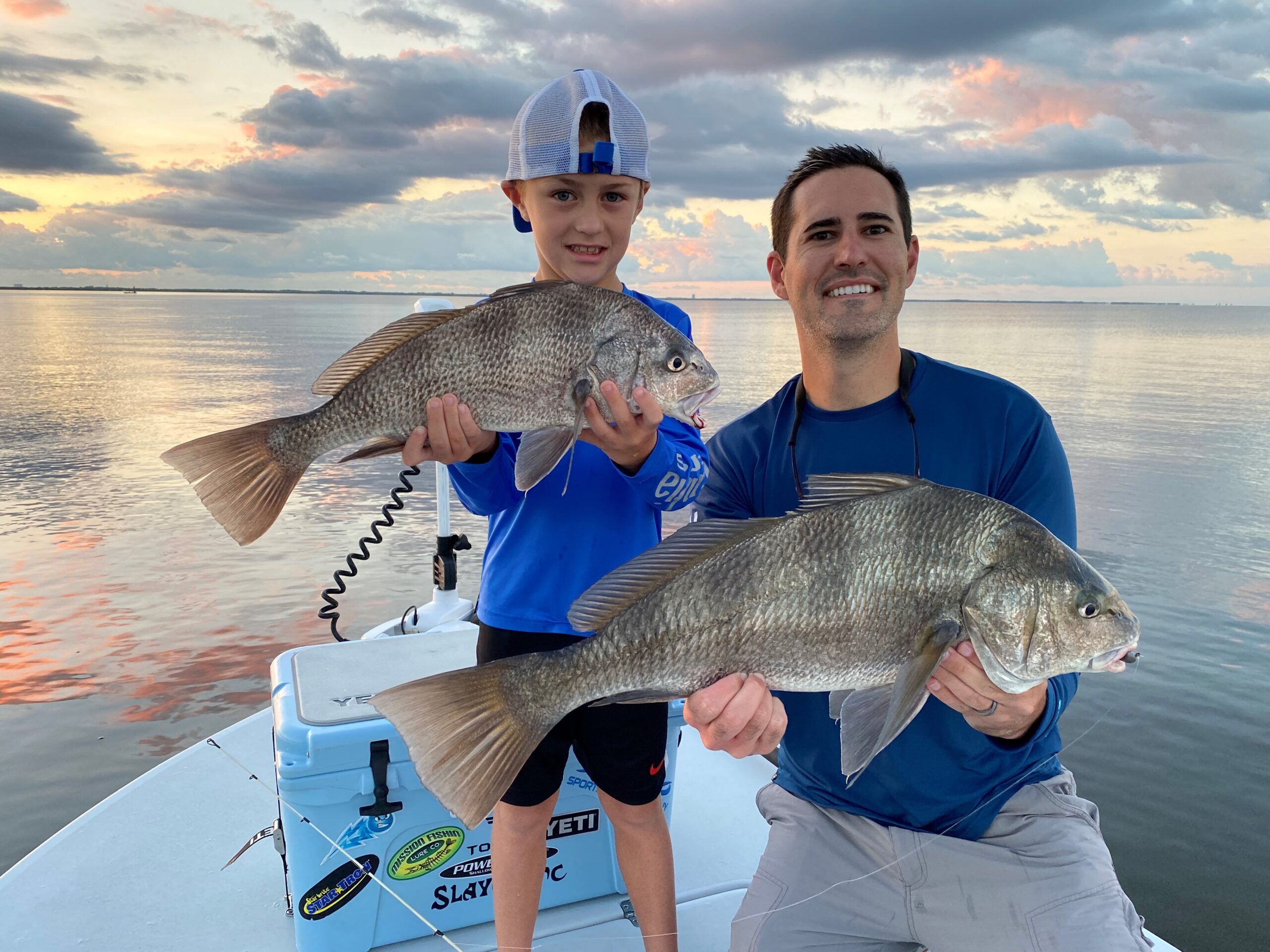 father and son with black drum
