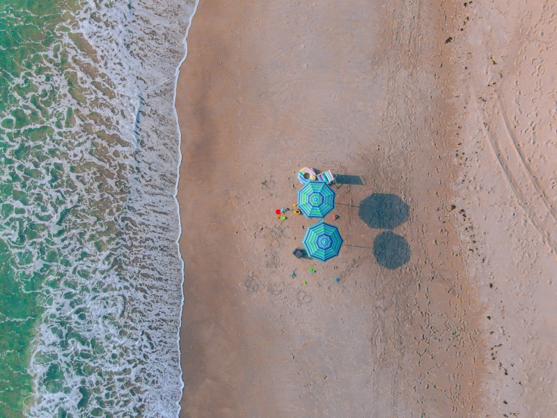 Overhead drone view of umbrellas on the beach